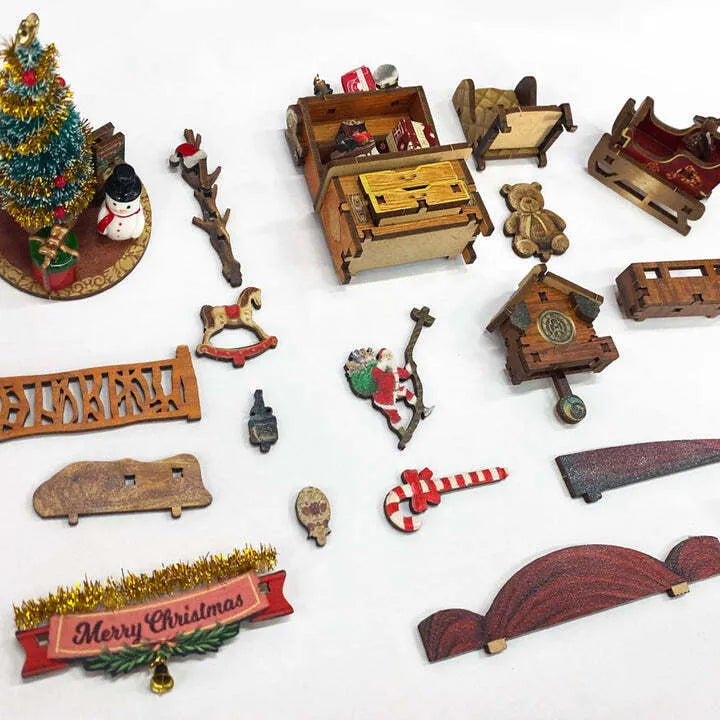 Book Nook - Christmas Jingle Cabin, un kit créatif pour construire un diorama miniature. Parfait pour décorer une bibliothèque ou comme cadeau original pour un amoureux des livres. Par Nookette.