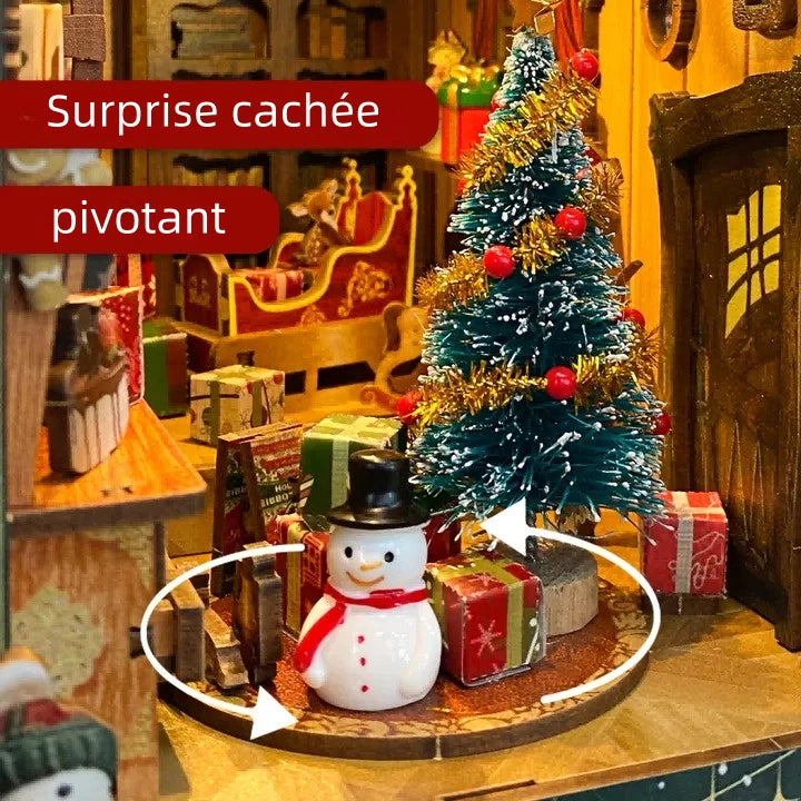 Book Nook - Christmas Jingle Cabin, un kit créatif pour construire un diorama miniature. Parfait pour décorer une bibliothèque ou comme cadeau original pour un amoureux des livres. Par Nookette.