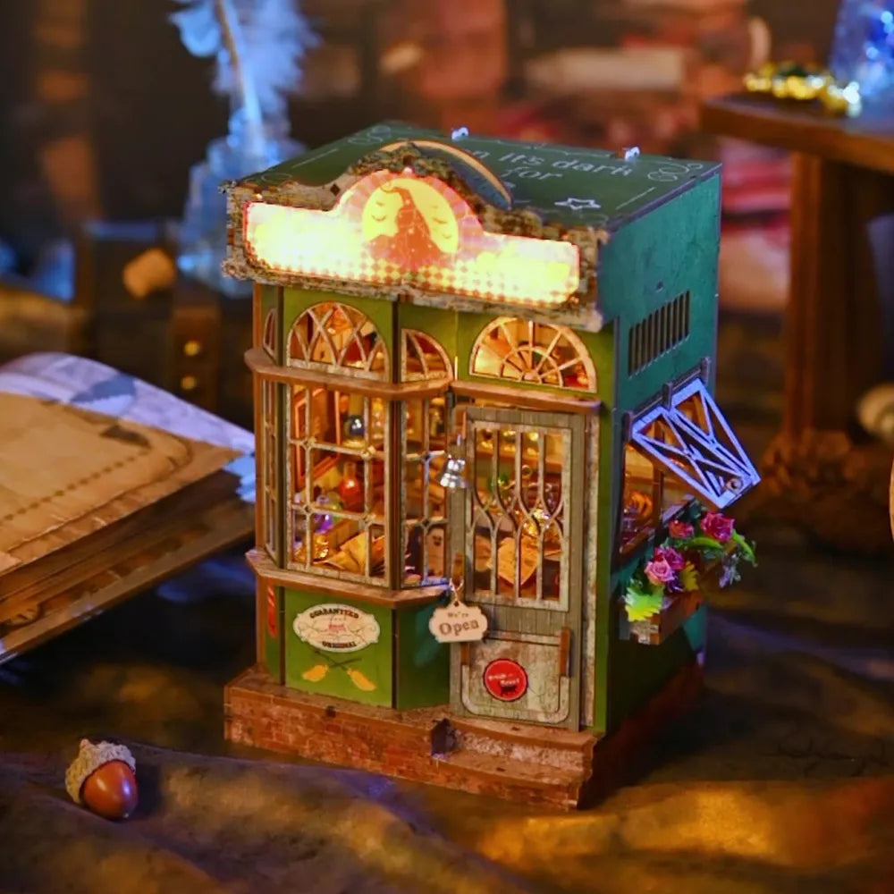 Book Nook - Magic Shop, un kit créatif pour construire un diorama miniature. Parfait pour décorer une bibliothèque ou comme cadeau original pour un amoureux des livres. Par Nookette.